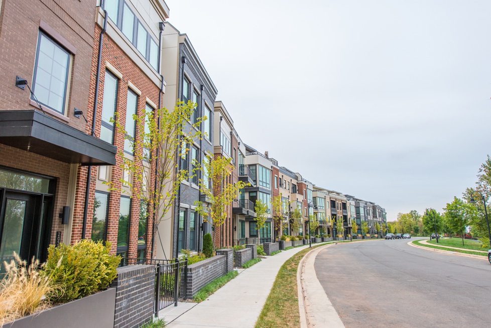 A row of houses on the side of a street.