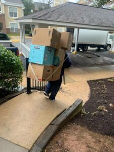 Person carrying boxes on their back.