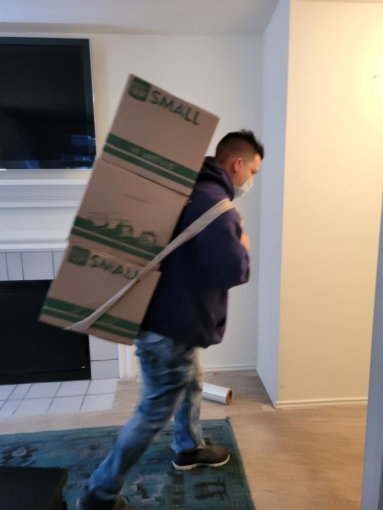 A man walking with a box on his back