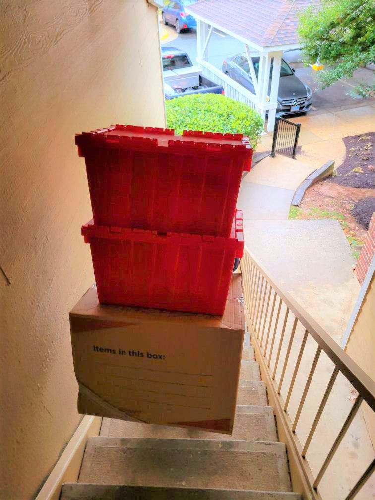 A red crate is on top of a box.