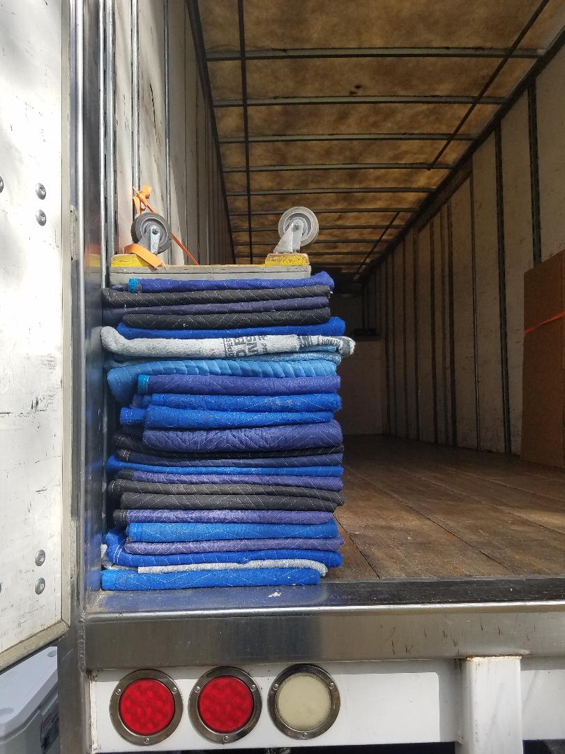 A truck full of blue blankets in the back