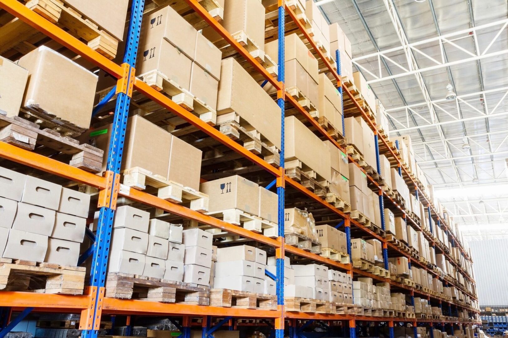 A warehouse filled with lots of boxes on shelves.