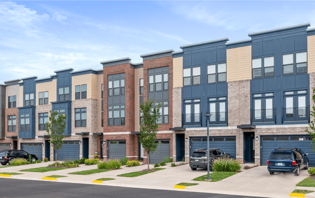 A row of houses on the side of a street.